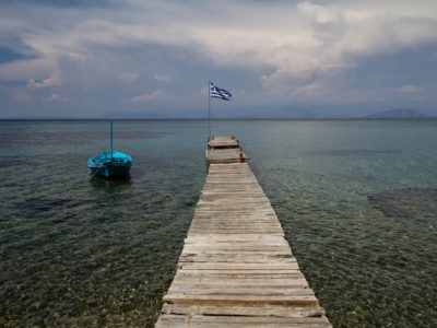 brown wooden dock with flag on top